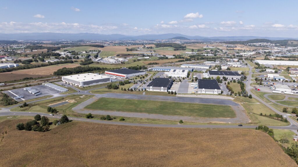 Aerial view of warehouse buildings with a vacant spot that is pad-ready.
